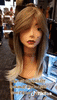 White Mannequin head with a tattooed necklaceon pink store counter modeling Empire Blonde Glueless Synthetic shoulder length Hair Wigs for $79 at Optimismic Wigs and Gifts Shop in St Paul Minnesota. 
