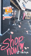 Pink air Waver and open wigs and Gifts sidewalk sign Outside view of 1201 S Robert Street Suite 8b in Signal Hills Shopping Center. Shop for Hair wigs for women and Gifts at Optimismic Wigs and Gifts St Paul Minnesota. 
