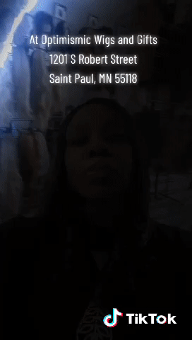 Tacandrya Patterson CEO modeling Black human hair lace front wigs and crystal bow tie necklace at Optimismic Wigs and Gifts St Paul Minnesota. 